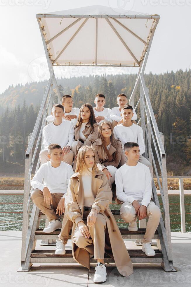 friendship, movement, action, freedom and people concepts - group of happy teenage students or school friends posing and having fun outdoors on beautiful place background. photo