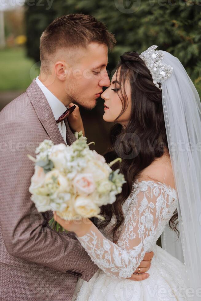 Wedding. Love and couple in garden for wedding. Celebration of ceremony and commitment. Save the date. Trust. The bride and groom embrace. Smile and love. Photo of happy and in love brides and grooms.