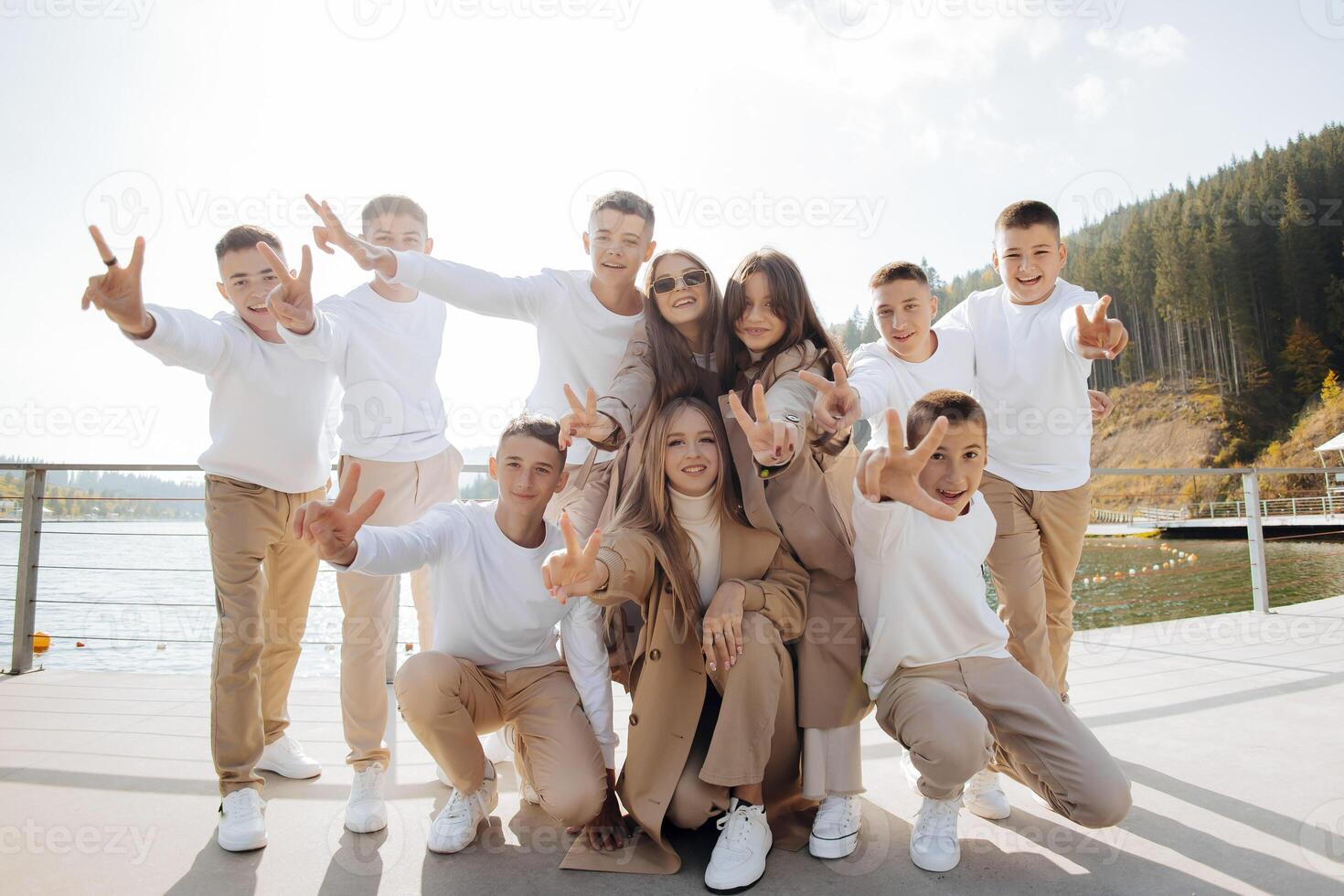 friendship, movement, action, freedom and people concepts - group of happy teenage students or school friends posing and having fun outdoors on beautiful place background. photo