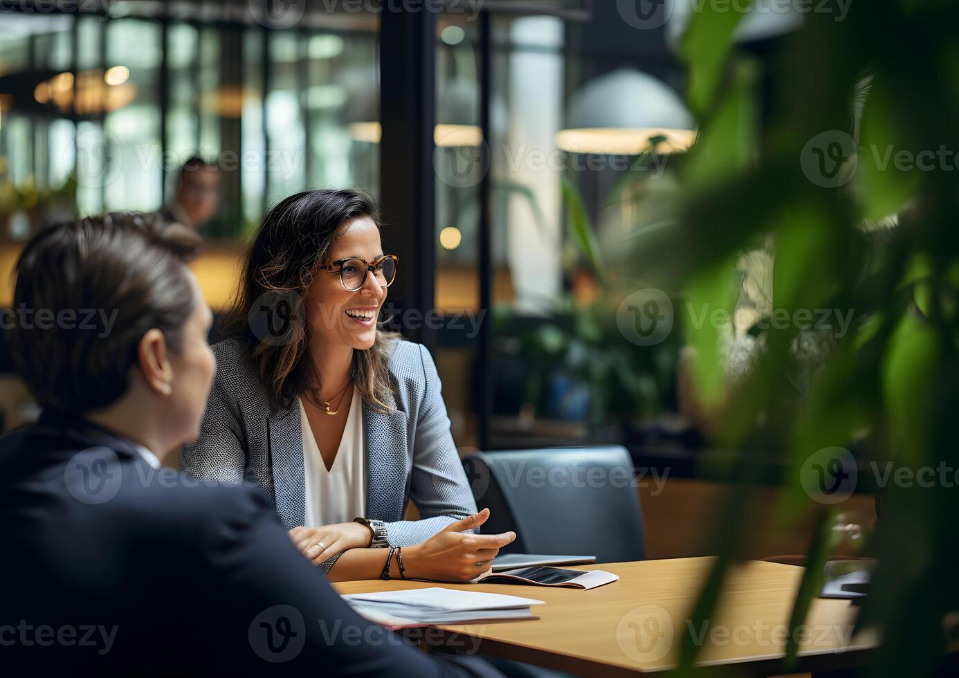 AI generated Smiling confident businesswoman leader in an office with team colleagues worker. Meeting in a boardroom. Using digital tablet and laptop during discussion. photo