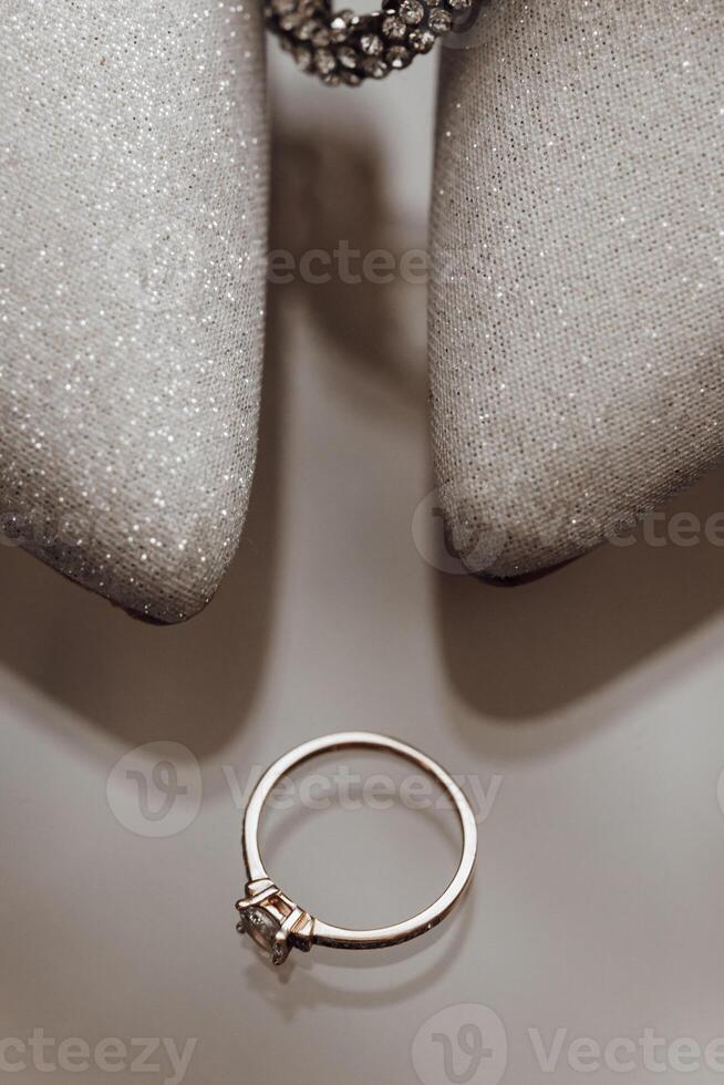 The bride's wedding ring is on the shoes, Perfume. Wedding details photo