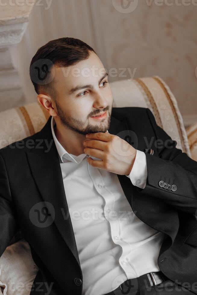 portrait of a handsome man in a hotel room in the morning. Preparation for an event or a new working day. New opportunities, acquaintances. Close-up portrait photo