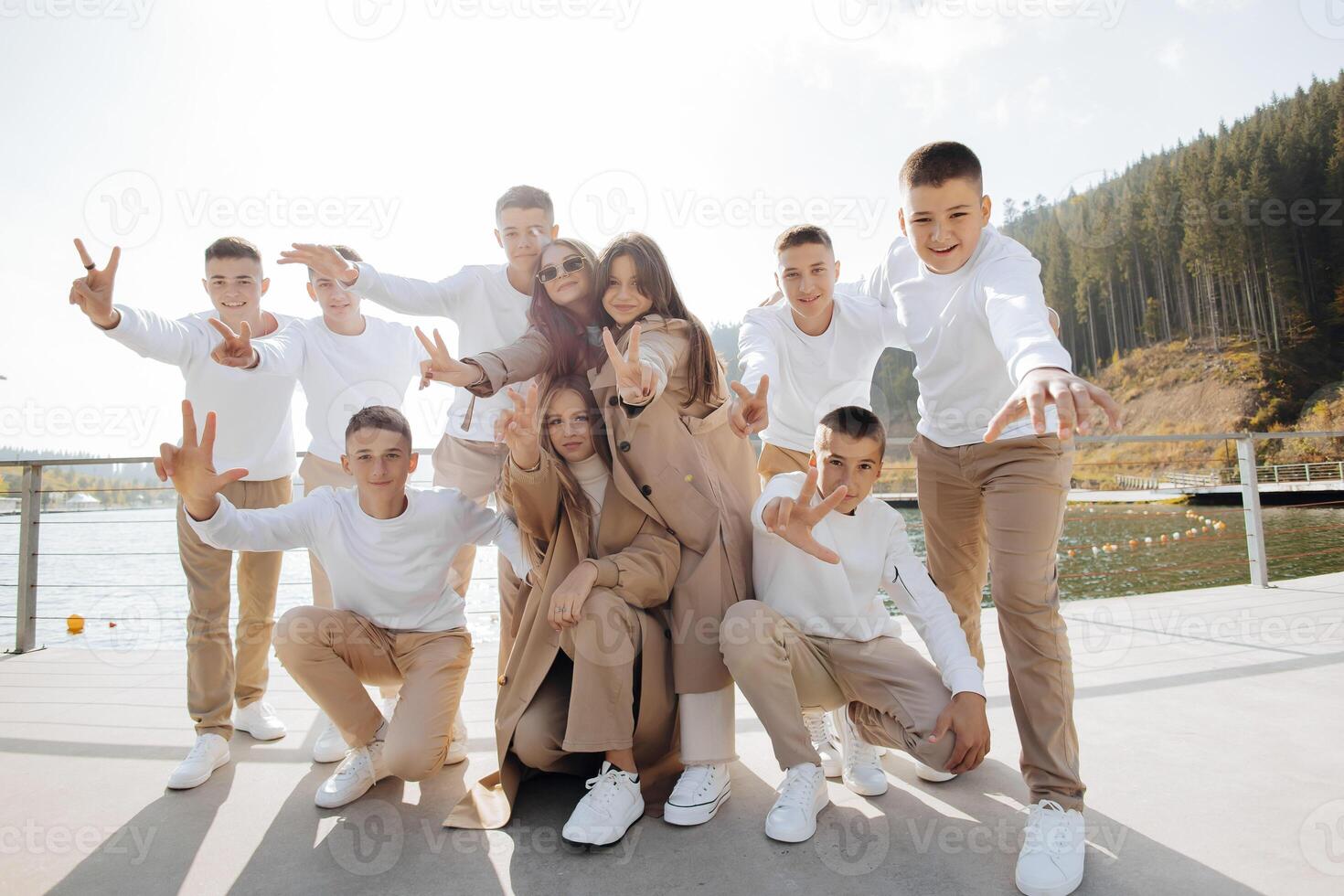 friendship, movement, action, freedom and people concepts - group of happy teenage students or school friends posing and having fun outdoors on beautiful place background. photo