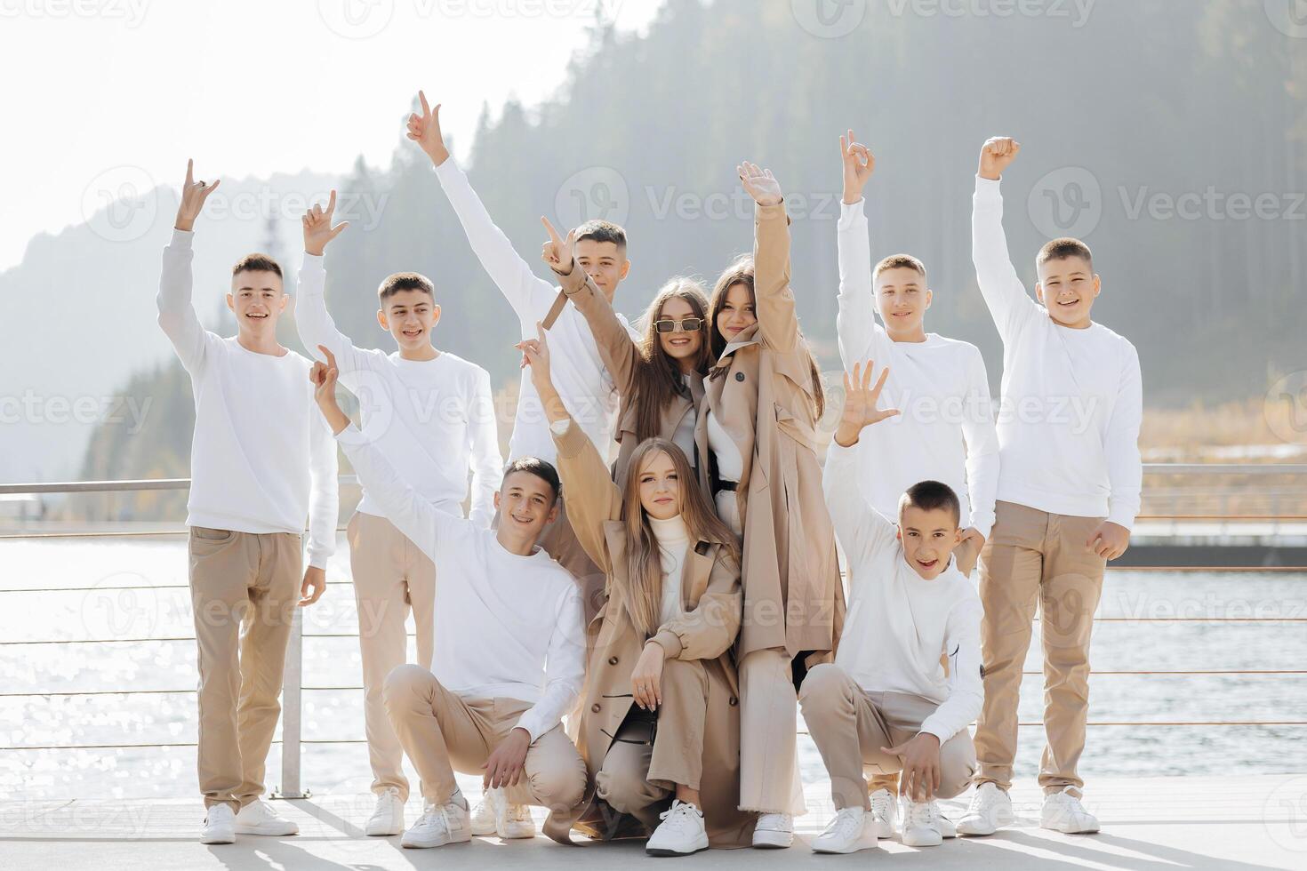 friendship, movement, action, freedom and people concepts - group of happy teenage students or school friends posing and having fun outdoors on beautiful place background. photo