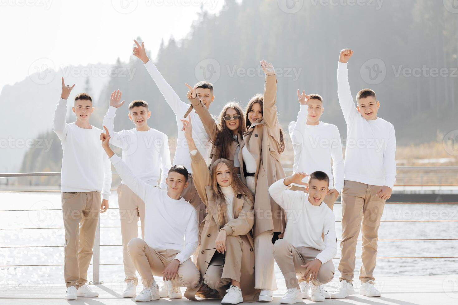 friendship, movement, action, freedom and people concepts - group of happy teenage students or school friends posing and having fun outdoors on beautiful place background. photo