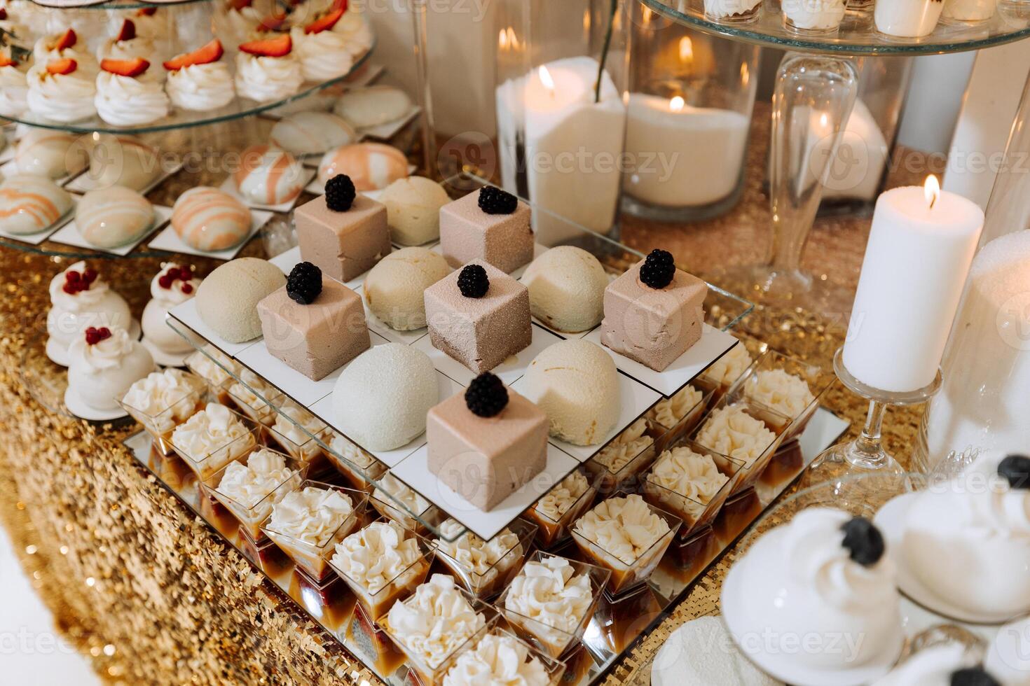 Candy bar for a wedding. Candy bar standing festive table with desserts, cupcakes and macarons. Beautiful and tasty. photo