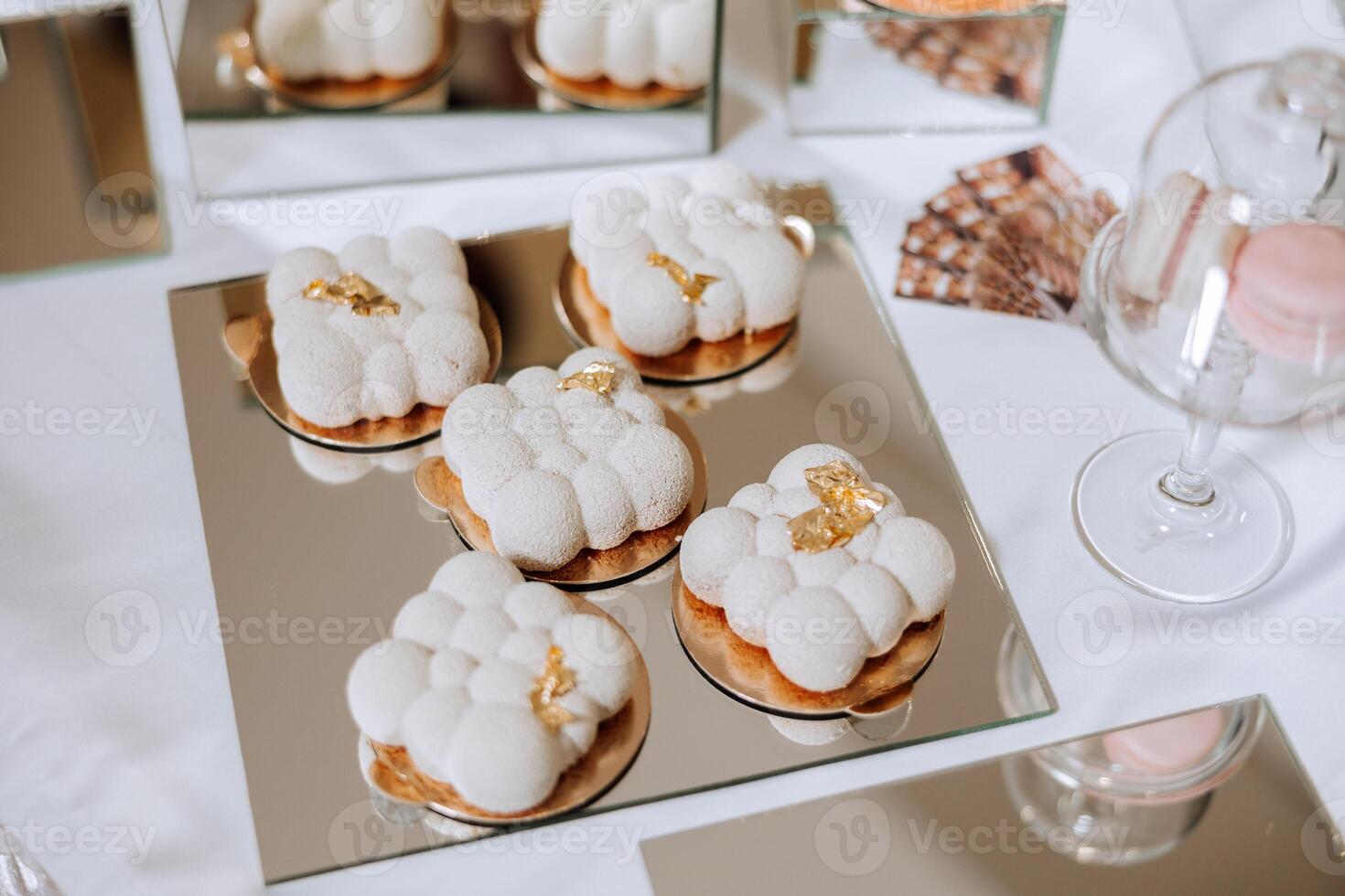 Almond cookies and various sweet cakes for a wedding banquet. A delicious reception, a luxurious ceremony. Table with sweets and desserts. Delicious colorful French desserts on a plate or table. photo