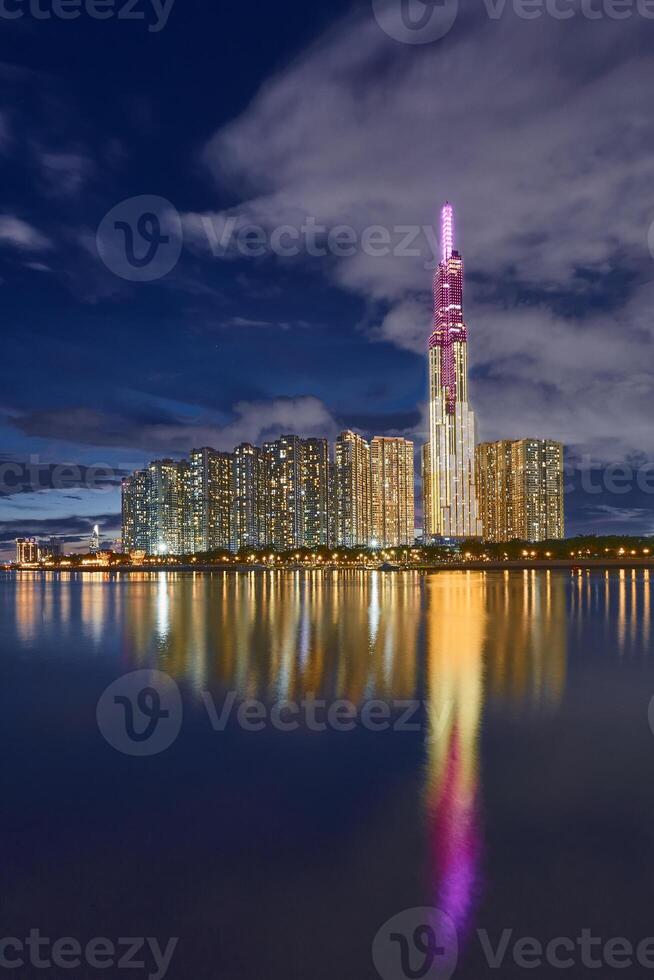 Ho Chi Minh City, Viet Nam 26 Oct 2023 Beautiful night at Landmarks 81 Ho Chi Minh City, the tallest building in Vietnam, with Vietnam flag on the top building. photo