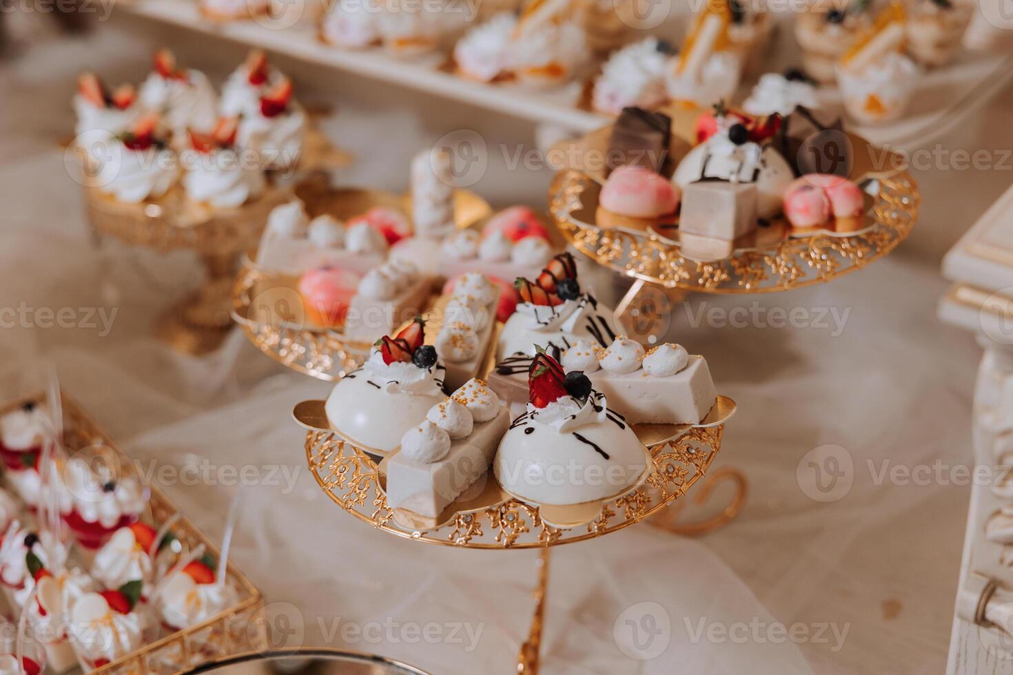 Almond cookies and various sweet cakes for a wedding banquet. A delicious reception, a luxurious ceremony. Table with sweets and desserts. Delicious colorful French desserts on a plate or table. photo