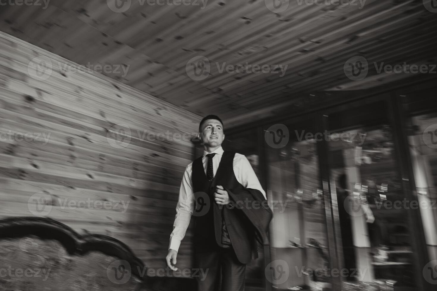 Stylish portrait of the groom preparing for the wedding ceremony in the morning. Groom's morning. Preparation for the groom's morning. The confident look of a mature man. Black and white photo