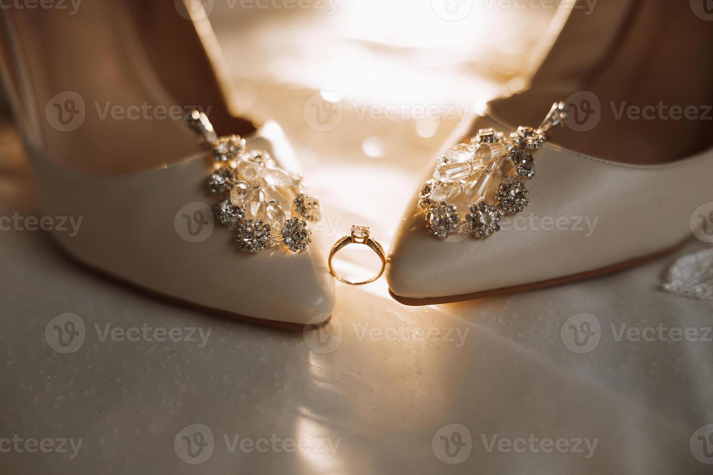 Details of the bride. Beauty is in the details. High-heeled bridal shoes. Gold wedding ring with a diamond. Perfumes. Earrings Wedding in details. photo