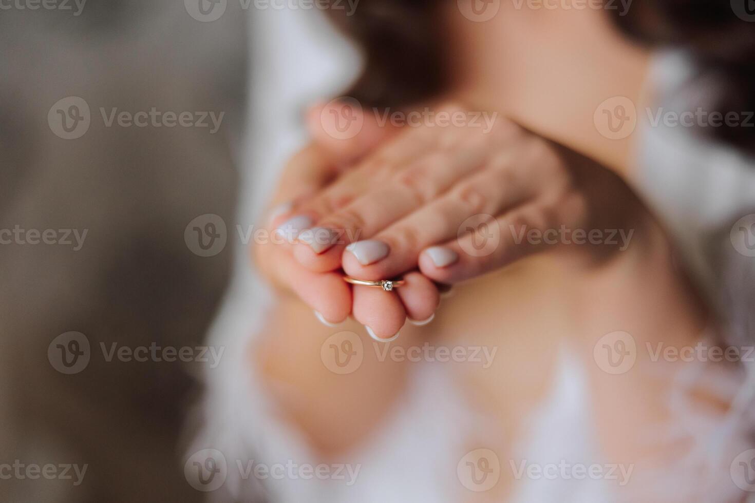 Close-up of an elegant diamond ring on a woman's finger with a modern manicure, sunlight. Love and wedding concept. Soft and selective focus. photo