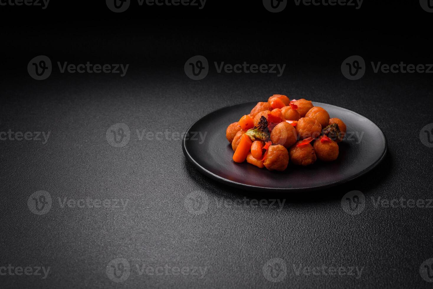 Delicious fried potato balls with vegetables, salt, spices and herbs photo