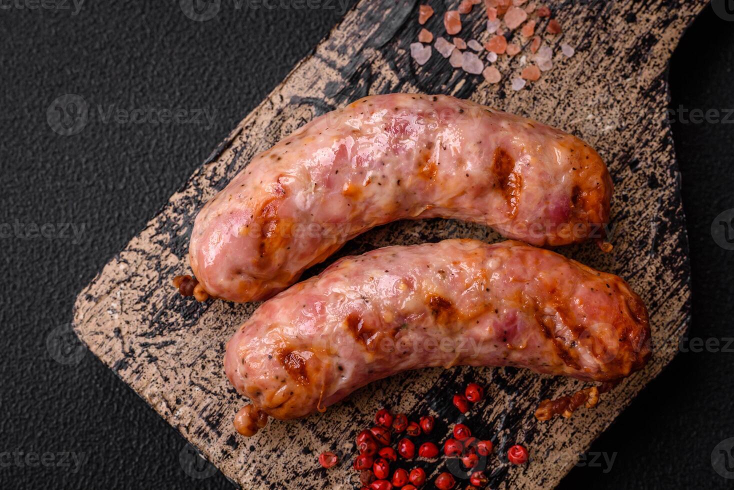 Delicious grilled chicken or pork sausages with salt and spices photo