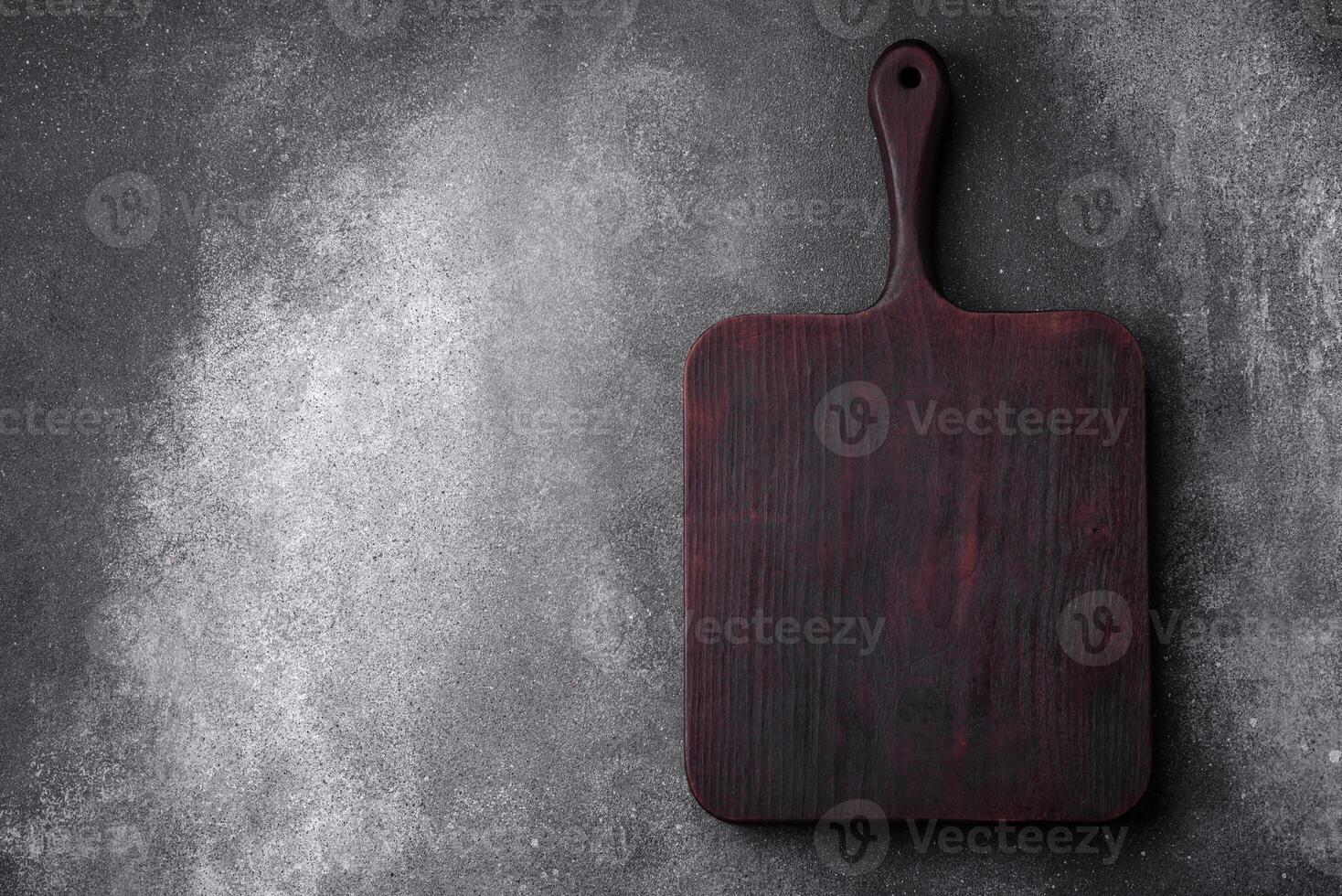 Empty wooden cutting board on a light texture background photo