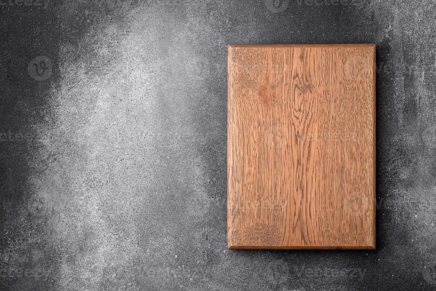 Empty wooden cutting board on a light texture background photo