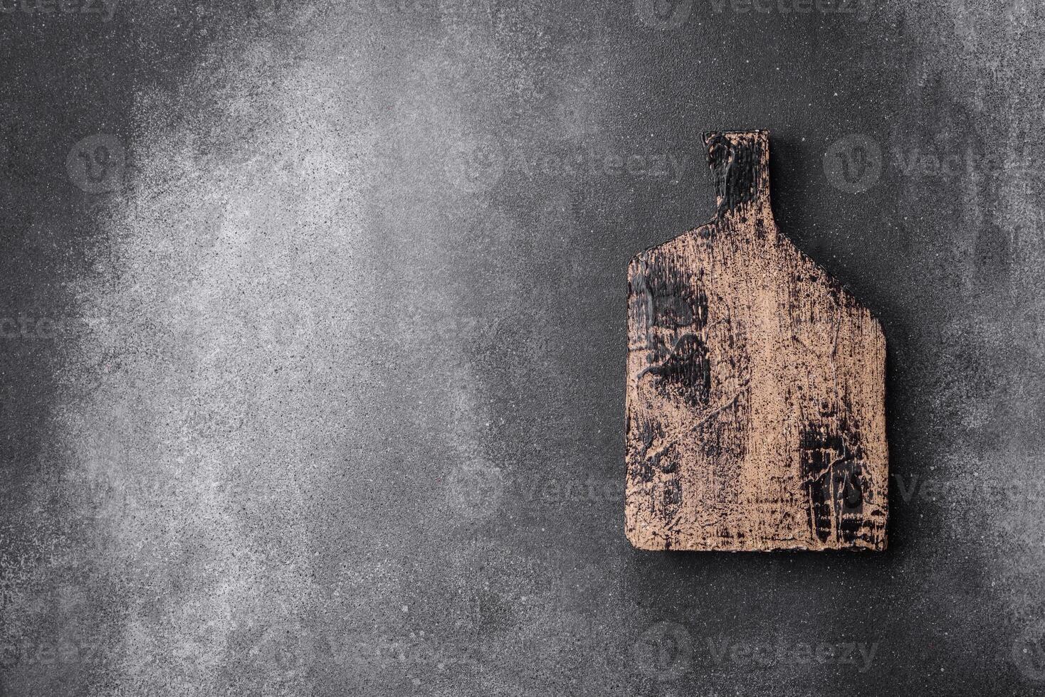 Empty wooden cutting board on a light texture background photo