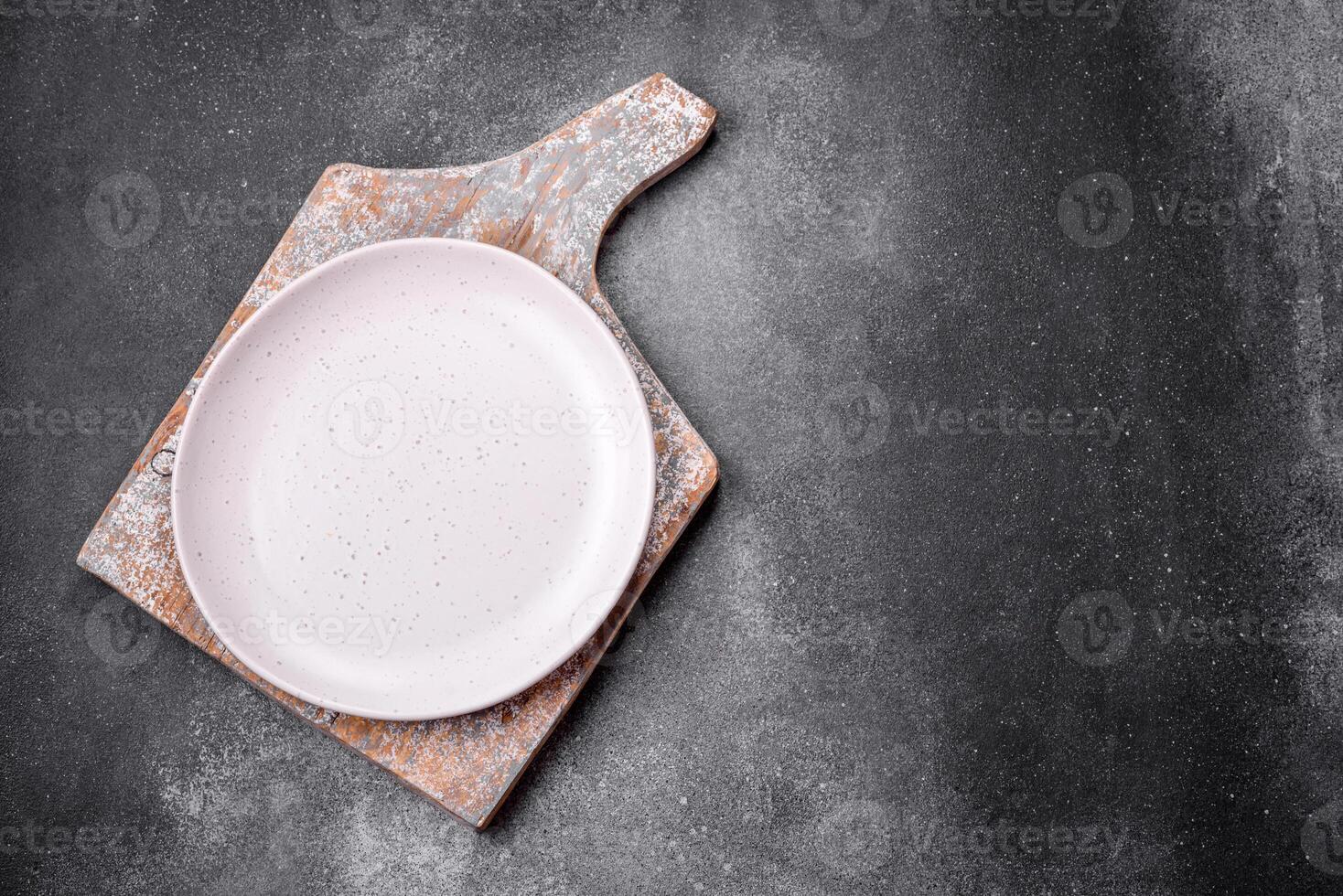 Empty round ceramic plate on a light texture background photo