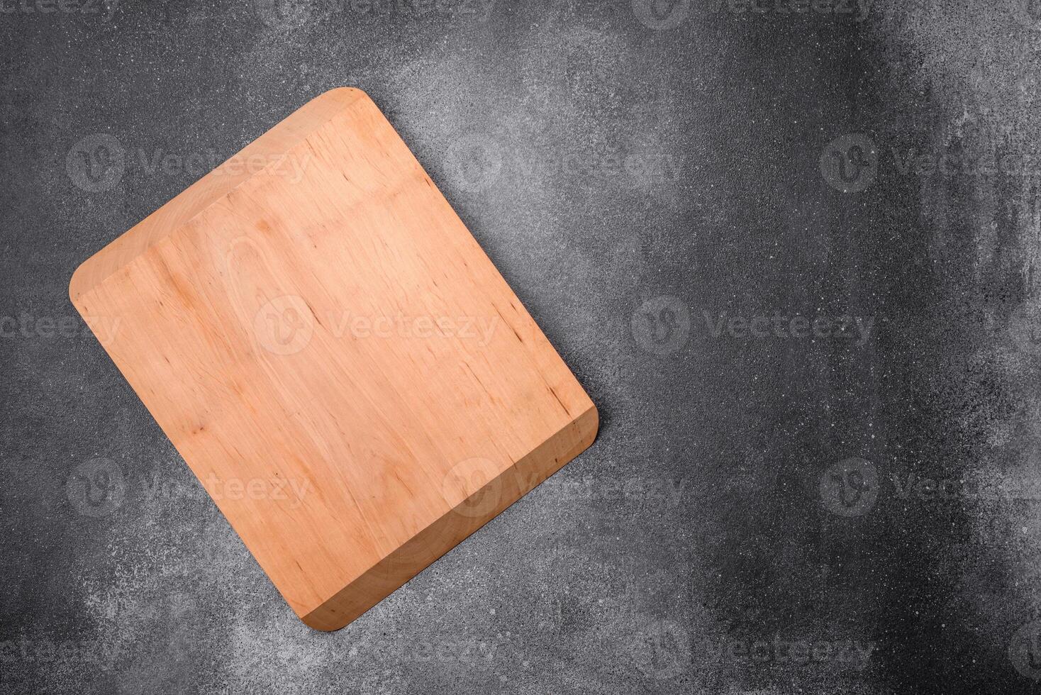 Empty wooden cutting board on a light texture background photo