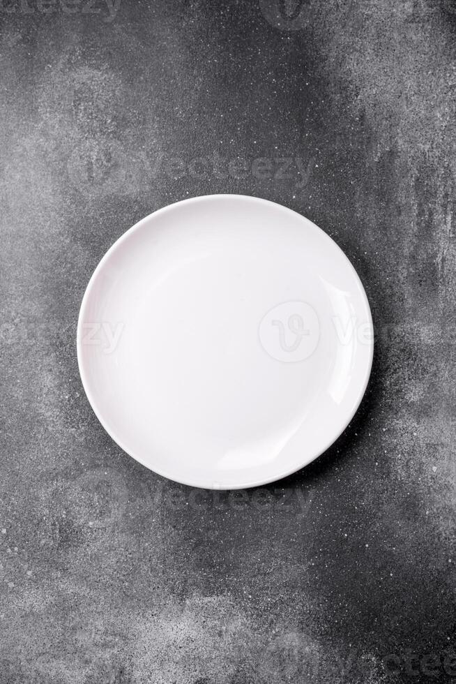 Empty round ceramic plate on a light texture background photo