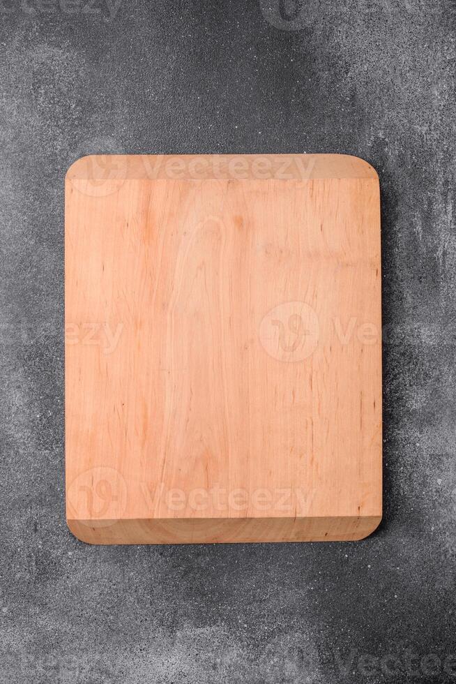 Empty wooden cutting board on a light texture background photo