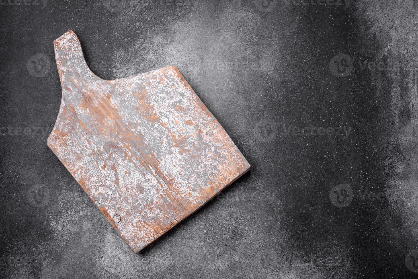 Empty wooden cutting board on a light texture background photo