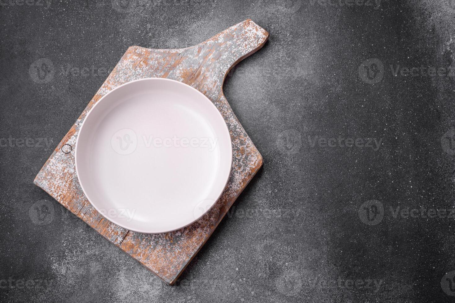 Empty round ceramic plate on a light texture background photo