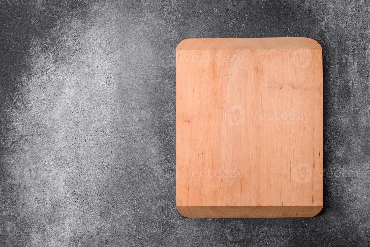Empty wooden cutting board on a light texture background photo