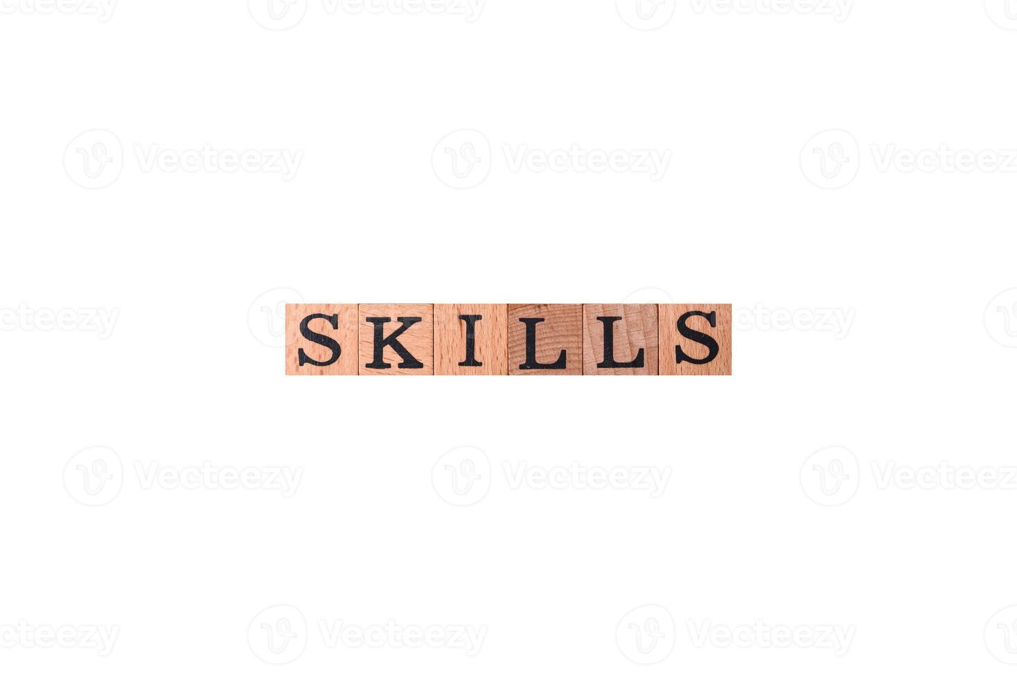 The inscription Skills made of wooden cubes on a plain background photo