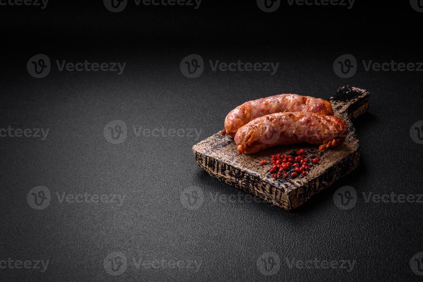 Delicious grilled chicken or pork sausages with salt and spices photo