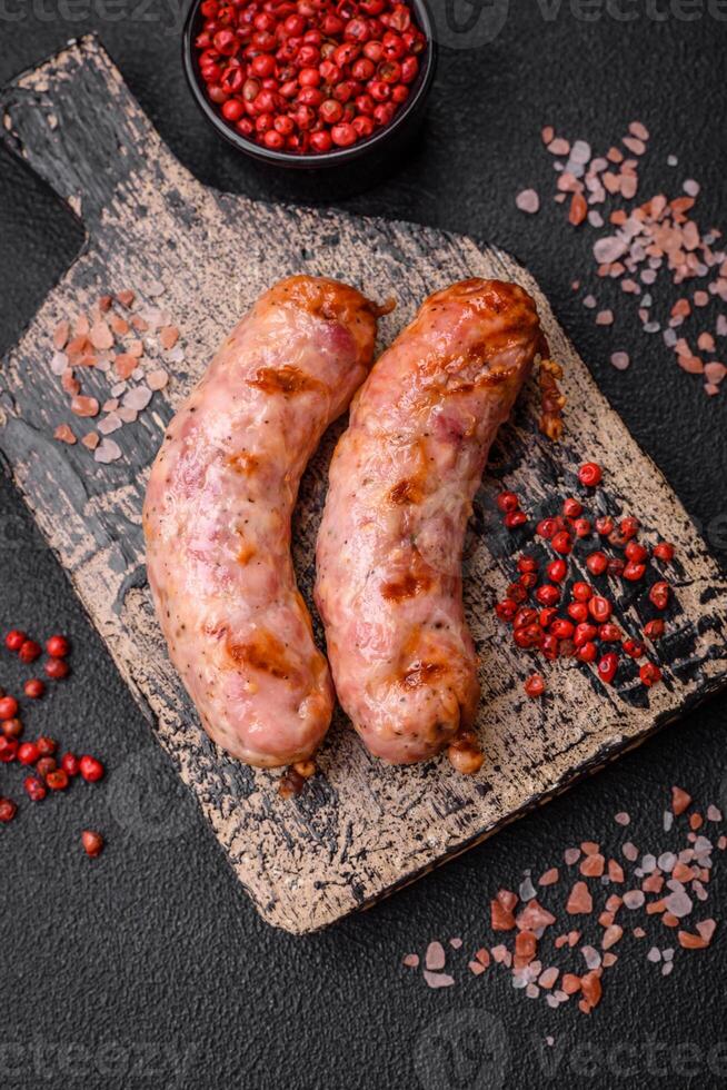 Delicious grilled chicken or pork sausages with salt and spices photo