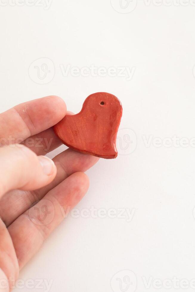 Concept love, valentine day. Hand with small red heart photo
