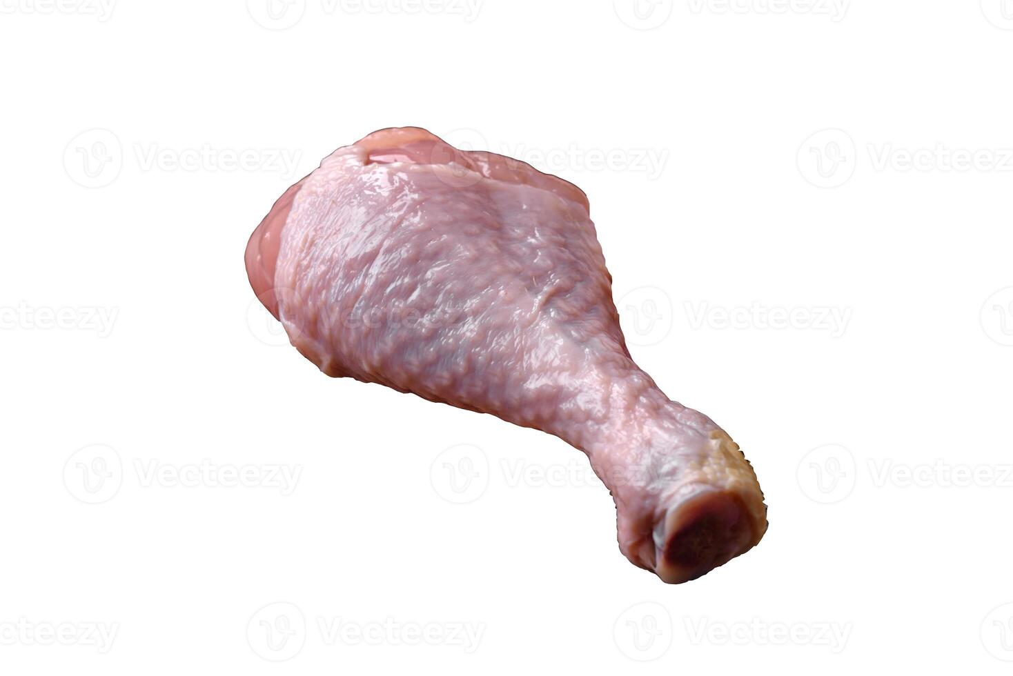 Raw chicken legs with salt, spices and herbs on a dark concrete background photo