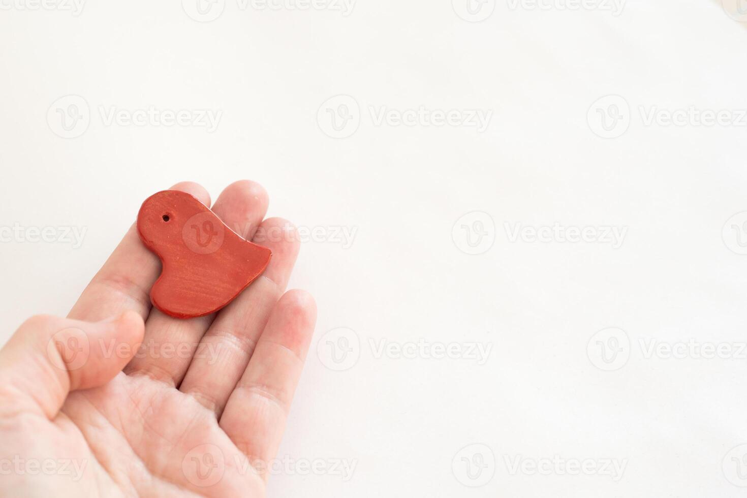 Concept love, valentine day. Hand wifh small red heart photo