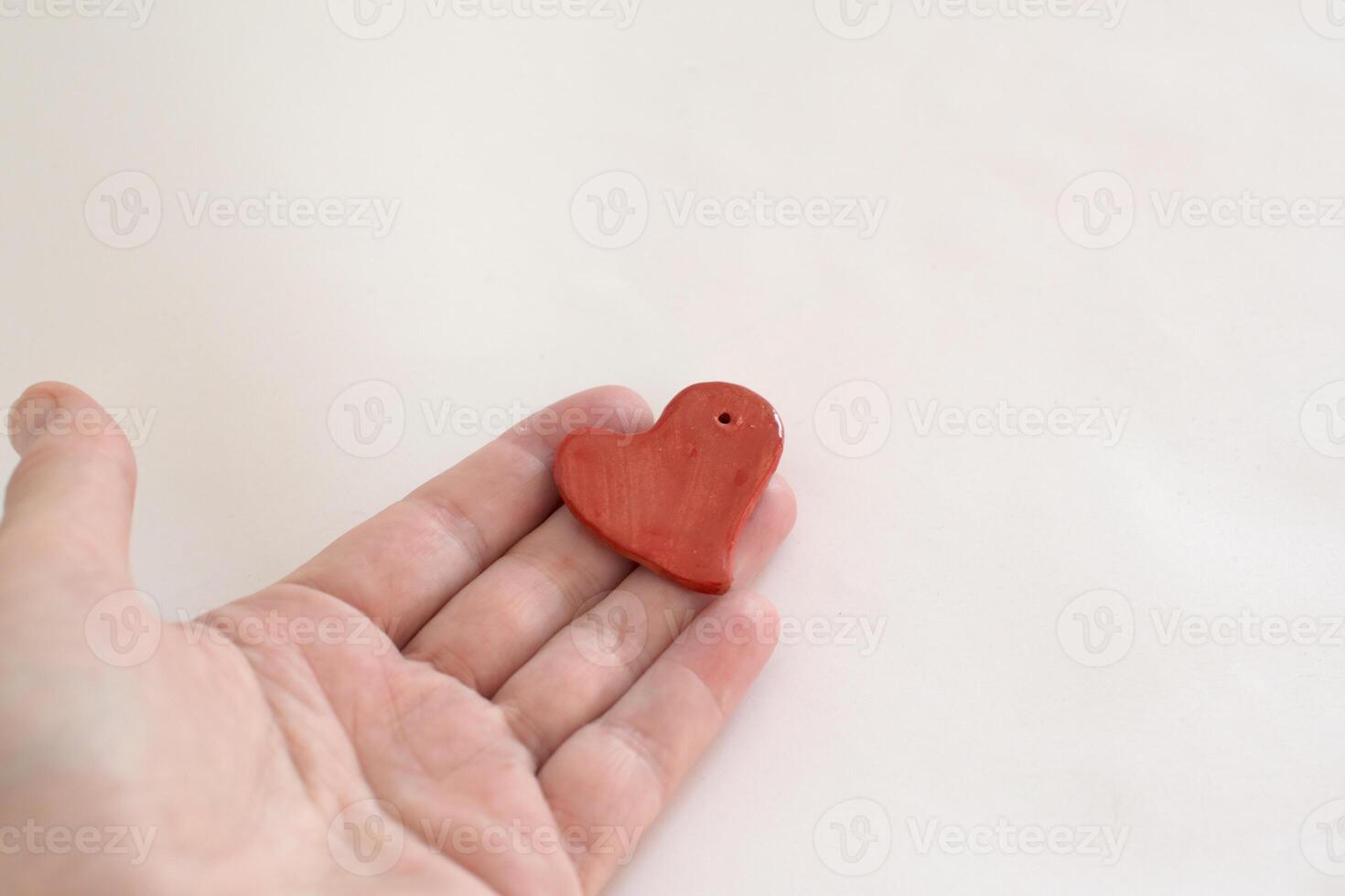 Organ donation for transplantation. Human hand with a small heart shaped piece photo