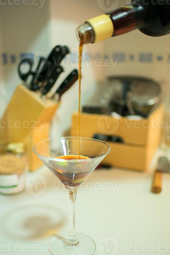 Pouring a martini glass in a domestic kitchen photo