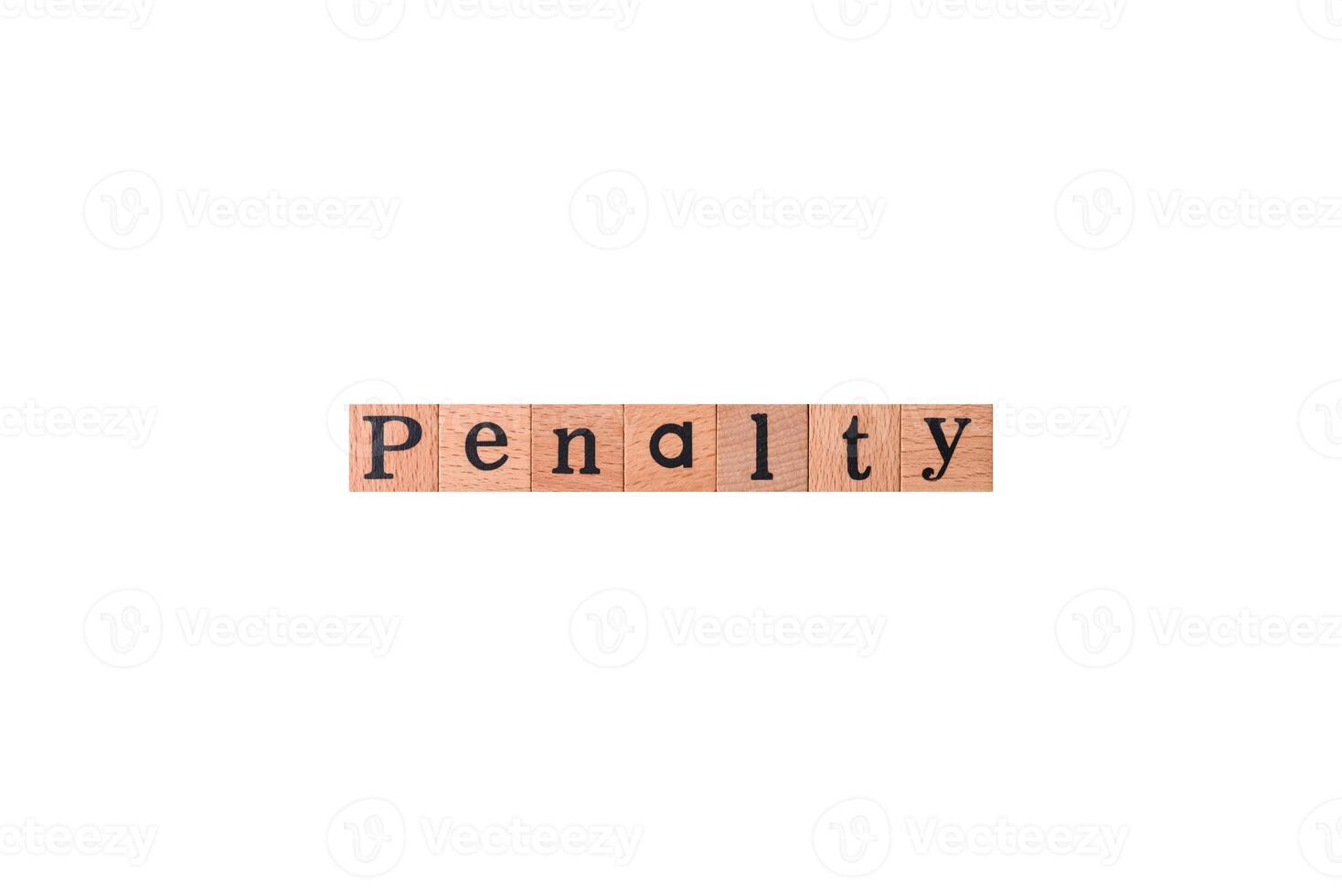 The inscription Penalty made up of wooden cubes on a plain background photo