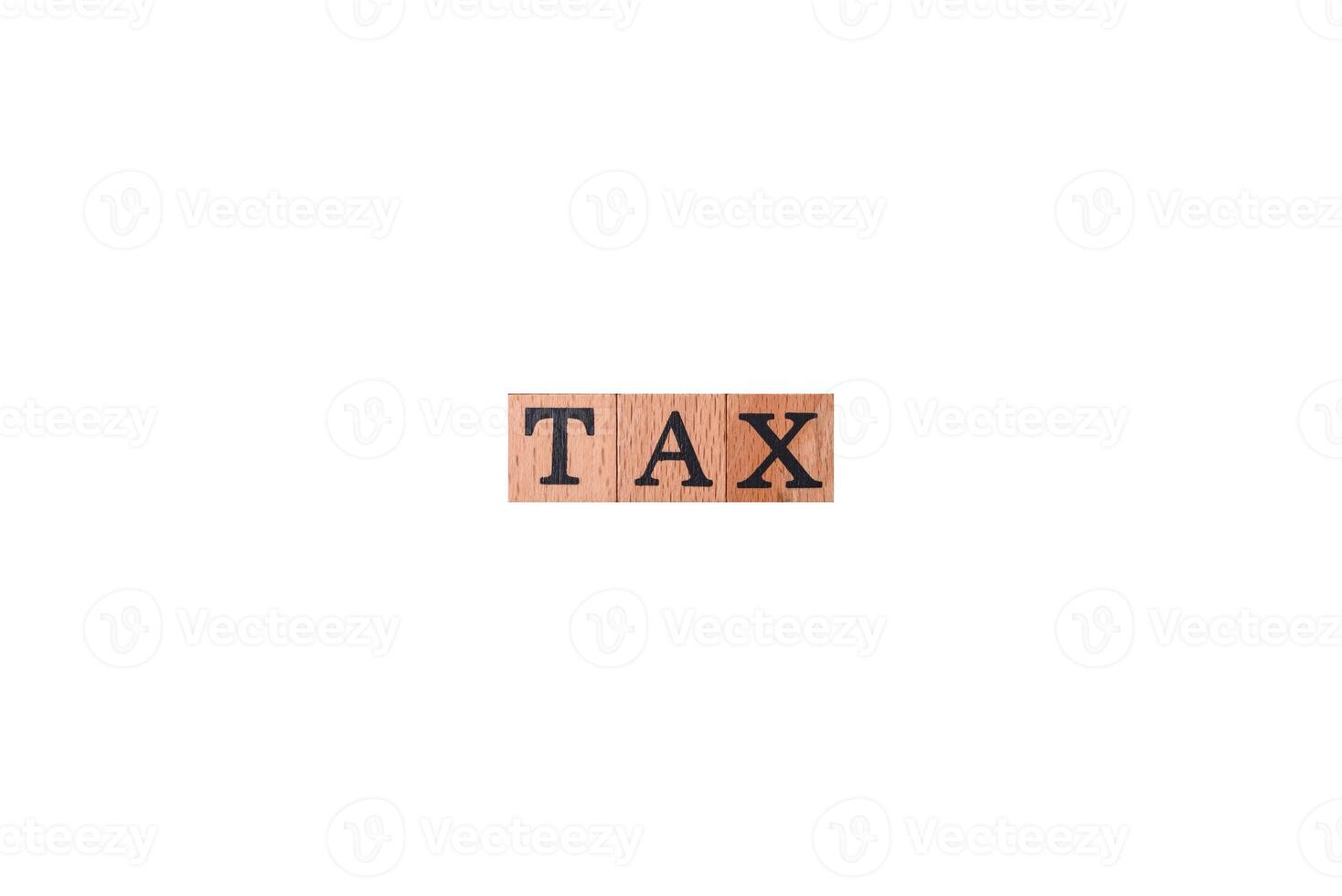 The inscription Tax made of wooden cubes on a plain background photo