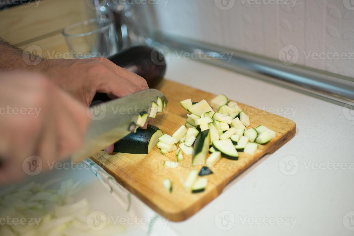 Caucasian man cutting zucchini photo