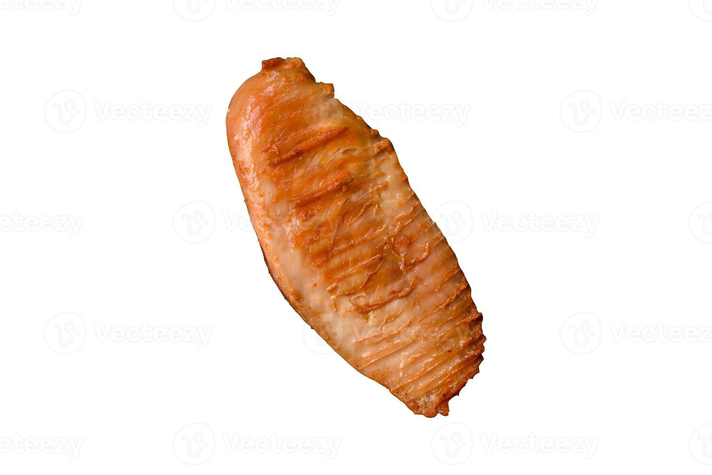 Delicious fresh grilled chicken fillet with spices and herbs on a dark concrete background photo