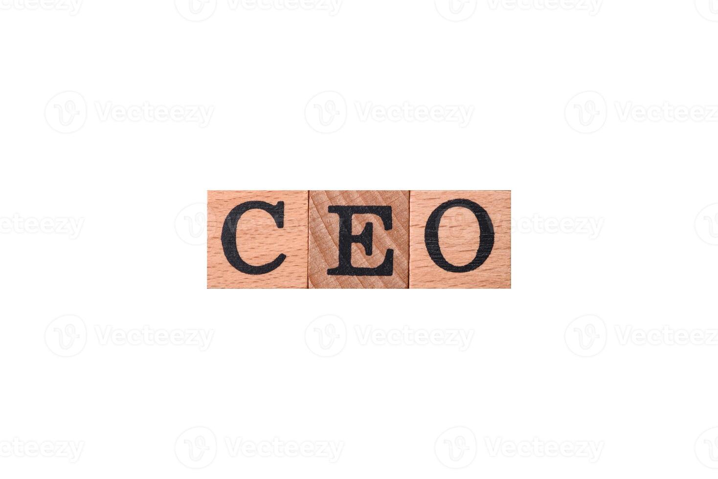 The inscription ceo in wooden cubes on a dark concrete background photo
