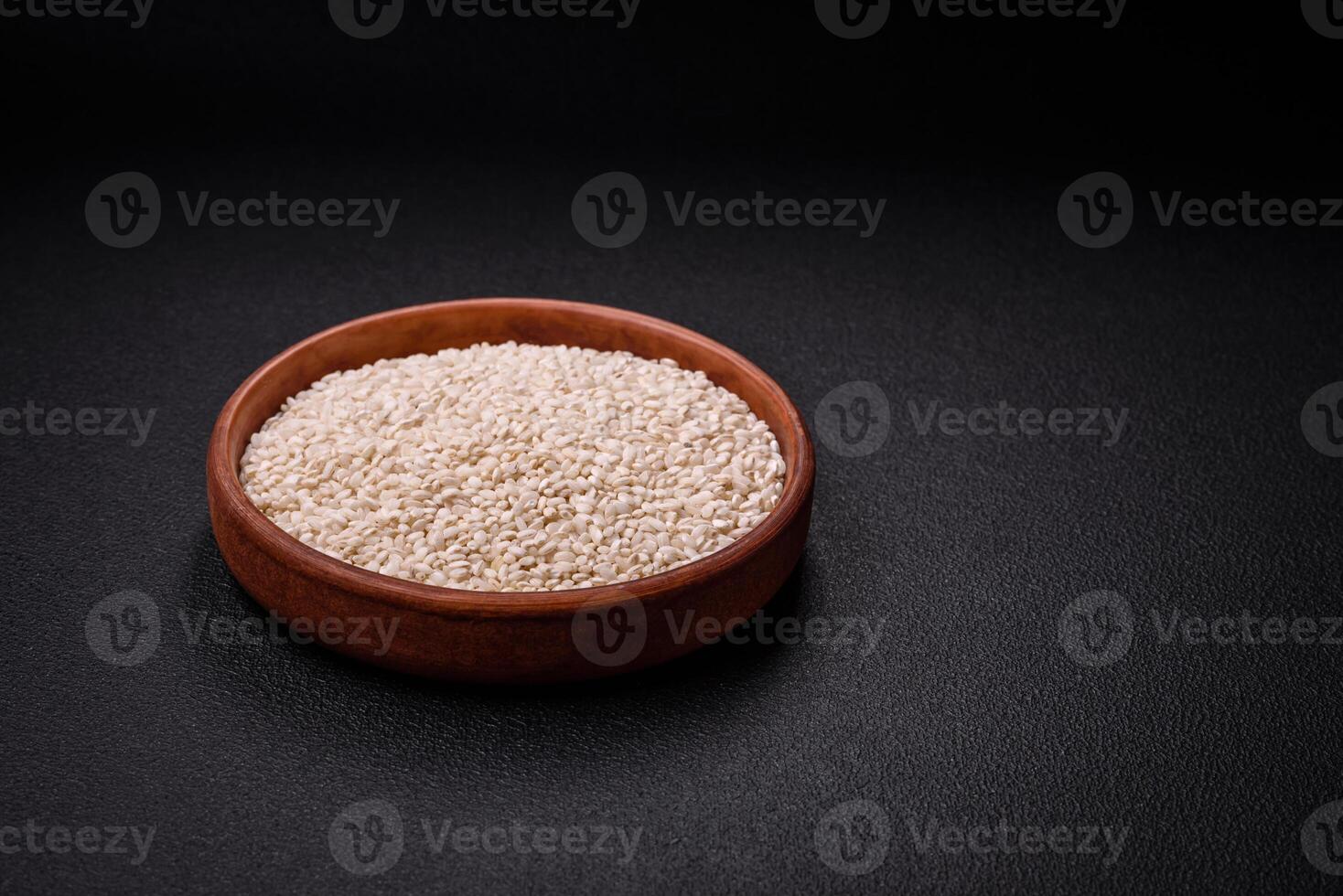 Large grains of uncooked white rice in a ceramic bowl photo