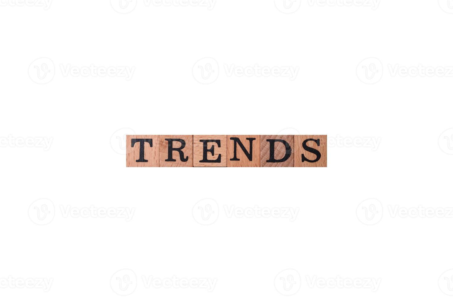 The inscription Trend made of wooden cubes on a plain background photo