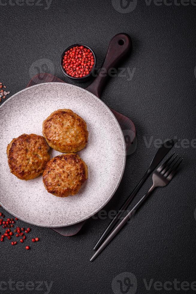 Delicious fresh fried minced fish cutlets with spices and herbs photo