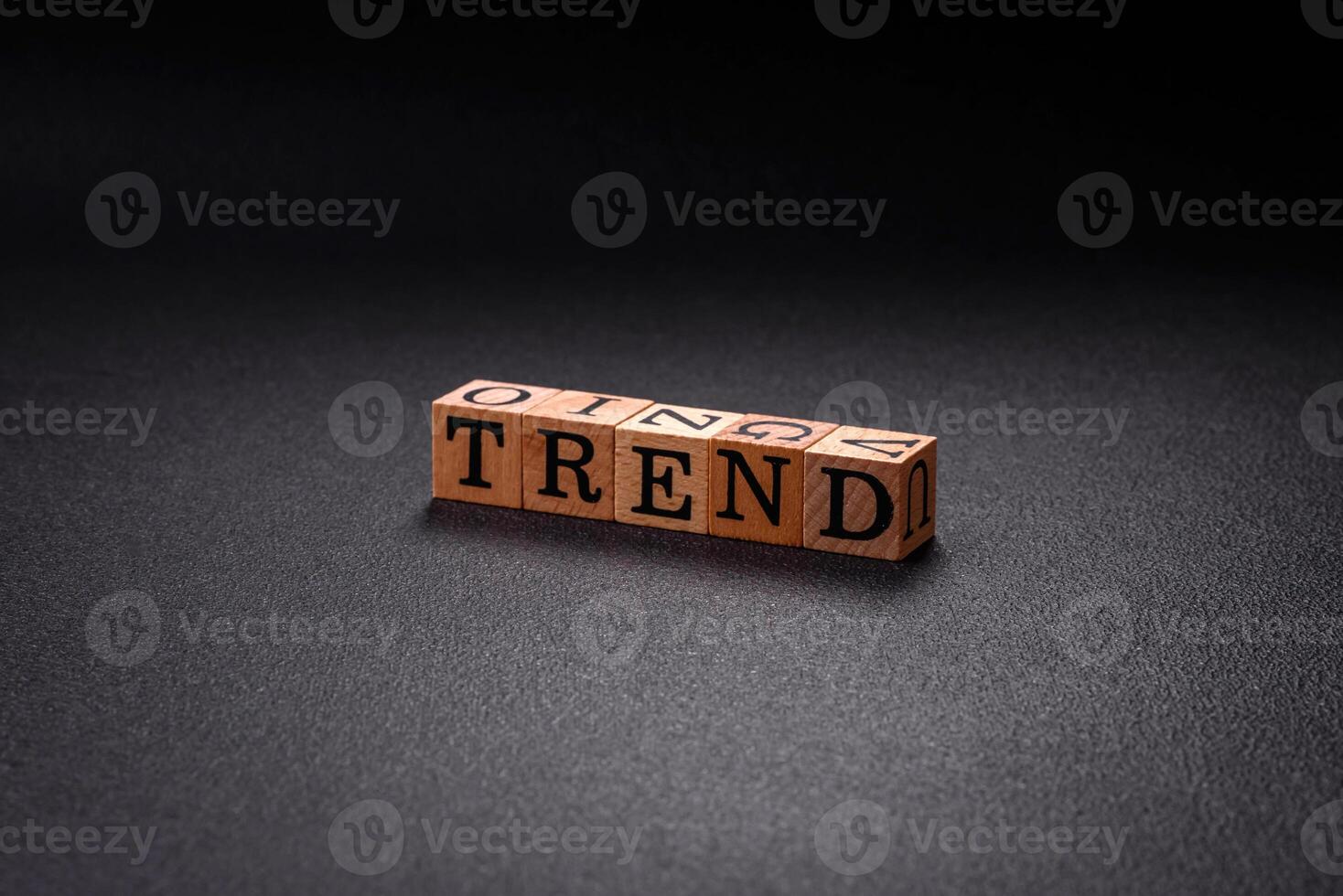 The inscription Trend made of wooden cubes on a plain background photo