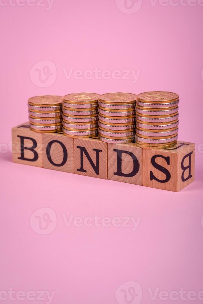 The inscription Bonds made of wooden cubes on a plain background photo