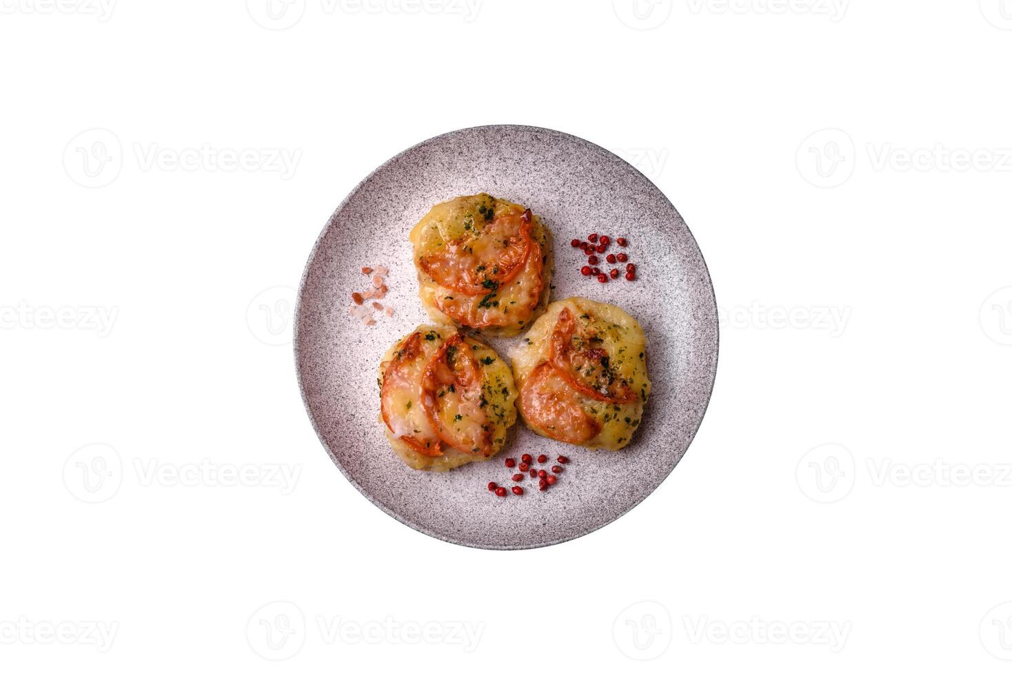 Delicious baked fish fillet with cheese, tomatoes, salt, spices and herbs photo