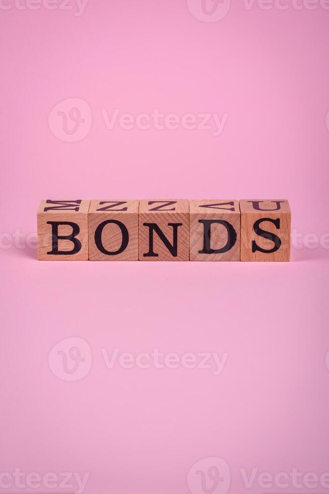 The inscription Bonds made of wooden cubes on a plain background photo