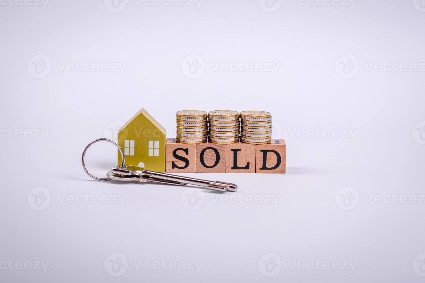 The inscription Sold made of wooden cubes on a plain background photo