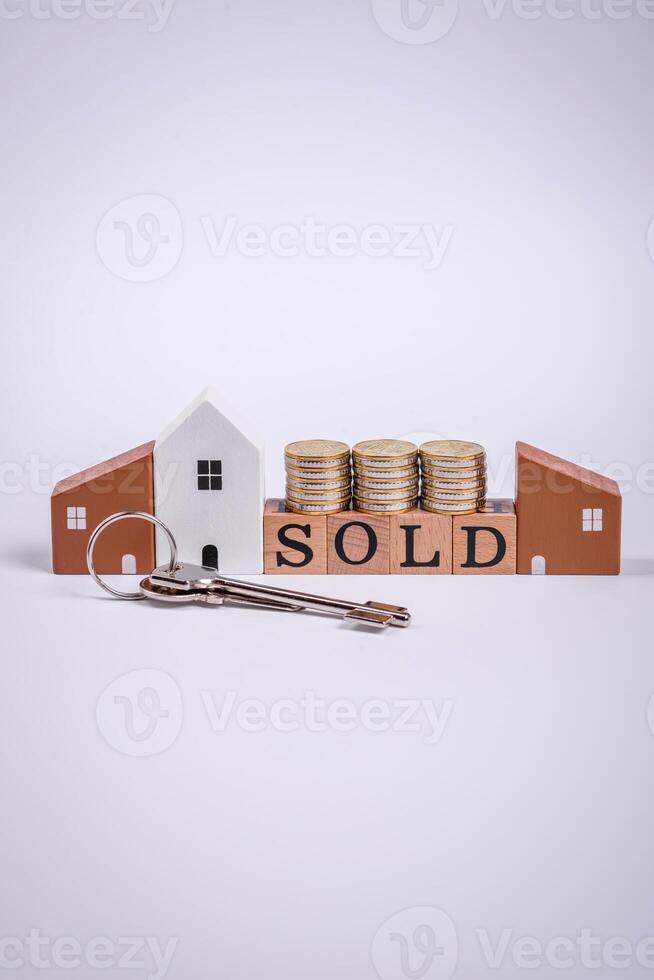 The inscription Sold made of wooden cubes on a plain background photo